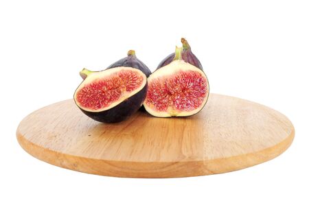 Fresh cut fig halves on wooden boardの写真素材