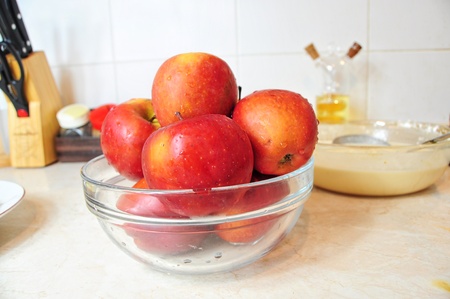 Bowl of fresh red apples on the kitchen counterの写真素材