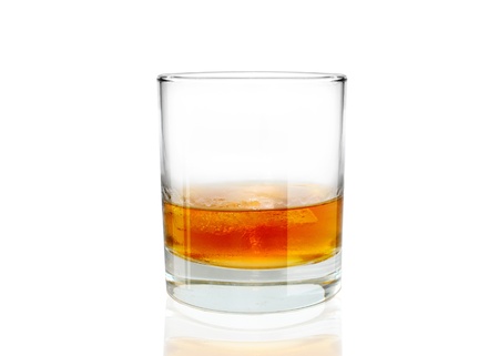 Glass of whiskey with ice on white backgroudの写真素材