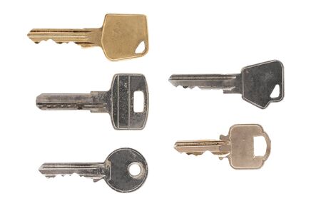 Five different kinds of door keys on white backgroundの写真素材