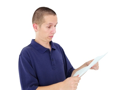 Young man looking at paper with surprise and disbeliefの写真素材