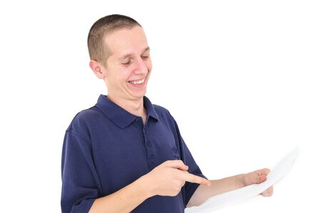 Young man looking at paper laughing and pointingの写真素材