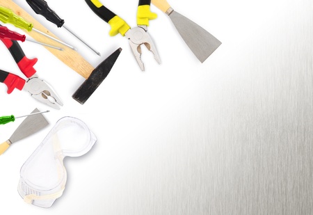 Different tools - hammer, plyers, screwdrivers,spatula, paint roller on metal surface with copyspaceの写真素材