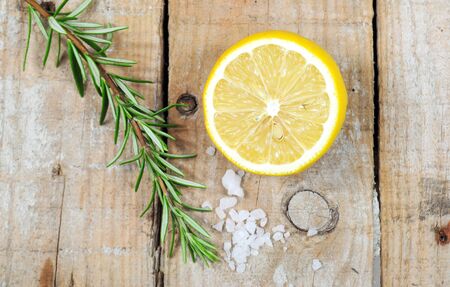 Mediterranean spices - rosemary, lemon, sea salt on wooden backgroundの写真素材
