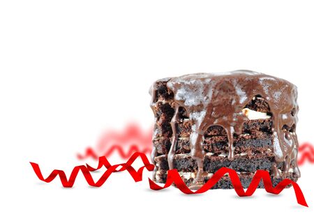 Chocolate cake with celebration ribbons isolated on whiteの写真素材