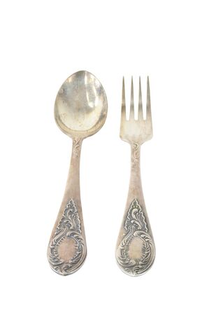 Vintage silver fork and spoon with ornaments isolated on white backgroundの写真素材
