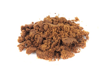 Closeup of pile of brown sugar isolated on whiteの写真素材