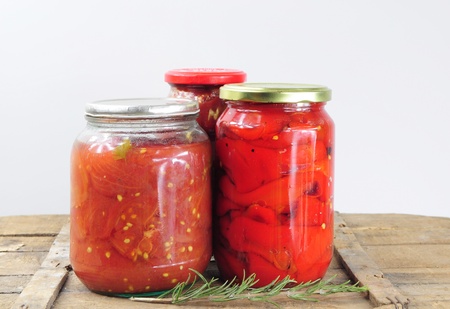 Food preservation. Jars with preserved tomatoes and peppersの写真素材
