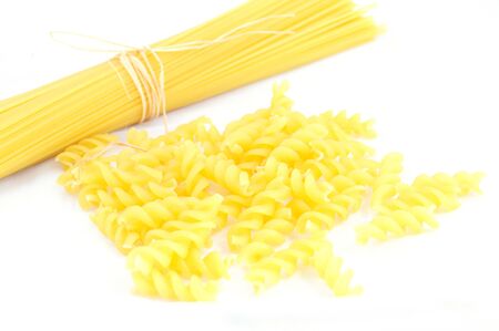 Closeup of spaghetti and fusilli on white background, focus on fusilliの写真素材