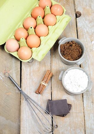 Ingredients for cake - flour, brown sugar, eggs, chocolate, cinnamonの写真素材