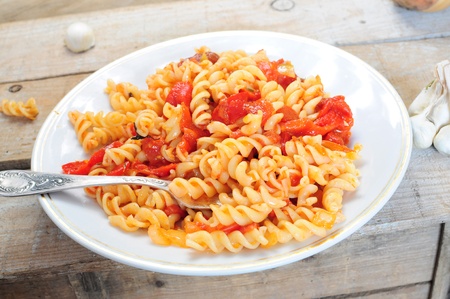 Pasta dish - cooked fusili with tomato and pepper sauceの写真素材