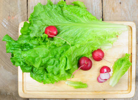 Top view of lettuce and radish on wooden backgroundの写真素材