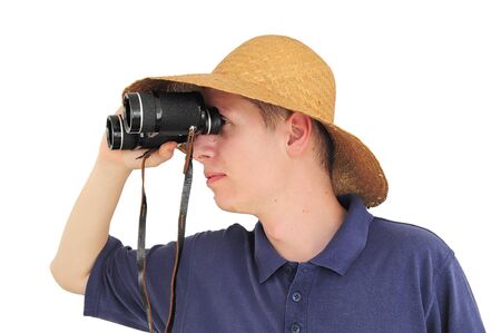 Young caucasian man with straw hat and binocularsの写真素材