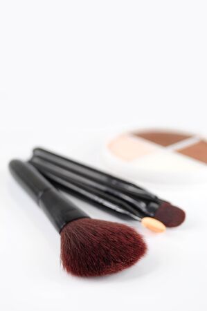 Closeup of brushes for makeup, eyeshadows in the backgroundの写真素材