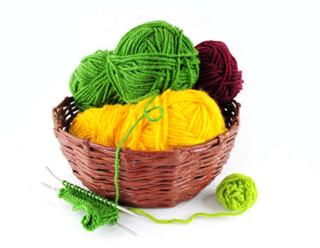 Colorful yarn and needles for knitting in wicker basketの写真素材