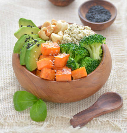 Buddha bowl with roasted sweet potatoes, avocado, cashew and hemp seedsの写真素材