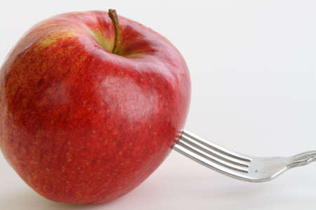 Fork in an Appleの写真素材