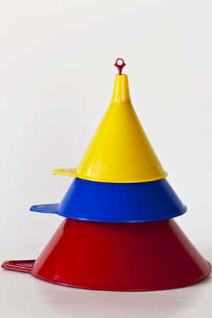 A set of three funnels stacked on eachother isolated on whiteの写真素材