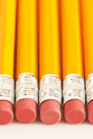 A line of pencils sits on top a white background.の写真素材