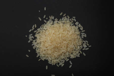 White rice isolated on black backgroundの写真素材