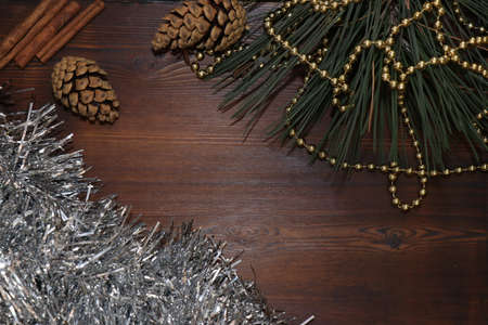 New year's background. Christmas decorations. Christmas toys and shiny beads. Wooden background. Holiday atmosphere. Pine branchの写真素材