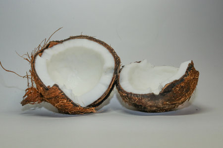 Two coconut halves isolated on a white background. Delicious nut.の写真素材