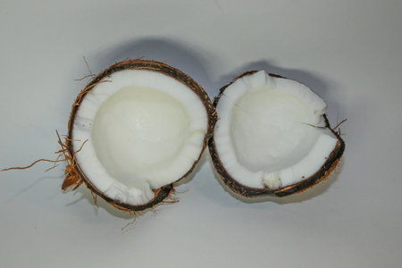Two coconut halves isolated on a white background. Delicious nut.