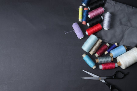 Colored threads and needles. Everything you need for sewing. Multiple spools of threads. Sharp...