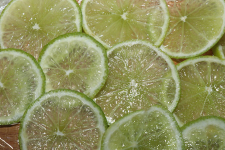 Slices of lime on a cutting board. close-up.の写真素材