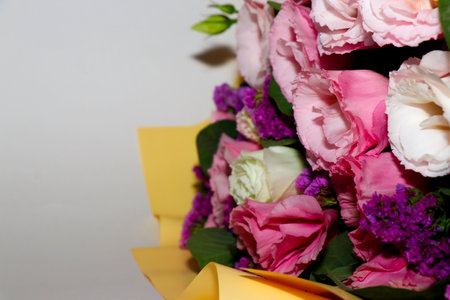 Bouquet of pink flowers in a vase on a white background