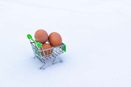 Three eggs in a cart on a white backgroundの写真素材