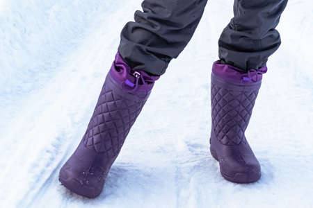 Women's purple EVA winter boots. Winter background.の写真素材