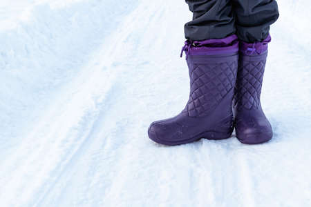 Beautiful womens purple EVA winter boots. Winter background.の写真素材