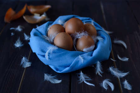 chicken eggs in a nest of blue cloth