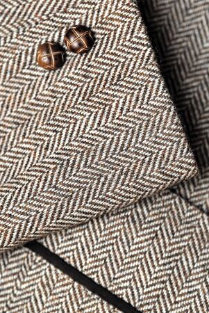 close-up of sleeve of tweed brown jacket with buttonsの写真素材