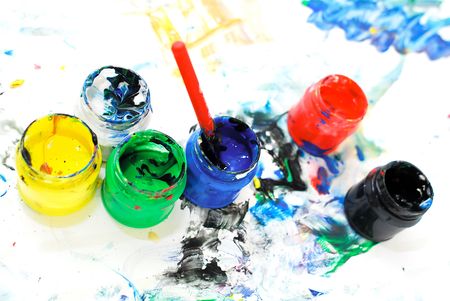 boxes of mixed paints with colored stains aroundの写真素材