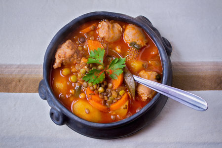 Traditional clay pot containing a lentil stew - tablecloth topの写真素材