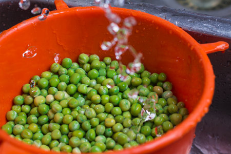 Green peas in a bowl of water, closeup of photo.の写真素材