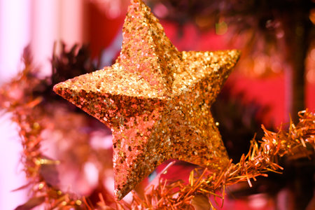 Christmas decoration with golden stars and tinsel. Shallow depth of field.