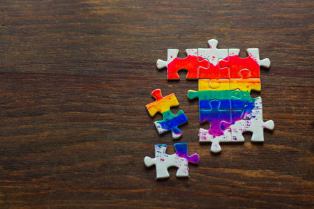 Colorful jigsaw puzzle pieces on wooden background with copy space.の写真素材