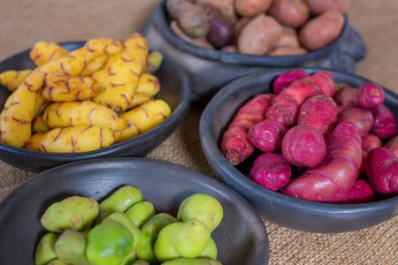 Potatoes and Potatoes in black bowls on a sackcloth backgroundの写真素材
