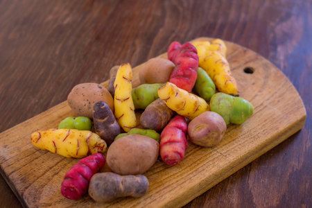 mix of fresh potatoes on wooden cutting board, healthy food, dietの写真素材