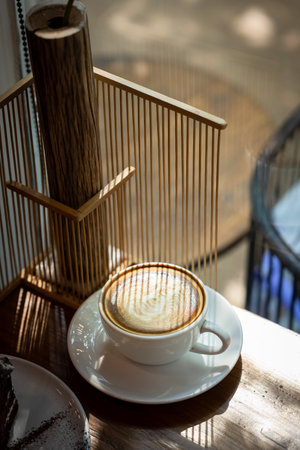 Coffee cup on wooden table in coffee shop cafe, stock photo