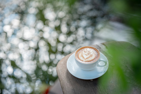 Hot art Latte Coffee.Background Coffee cup and beans on old kitchen table.の写真素材