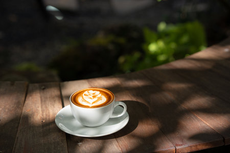 Hot art Latte Coffee.Background Coffee cup and beans on old kitchen table.の写真素材