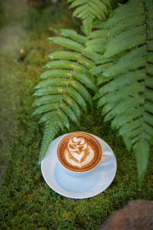Hot art Latte Coffee.Background Coffee cup and beans on old kitchen table.の写真素材