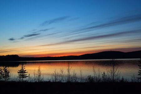 Sunset in swedish lapland reflecting in waterの写真素材