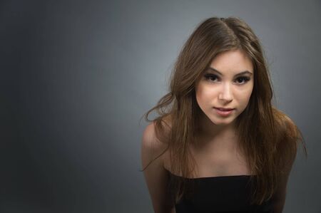 Pretty woman looking up on you with big brown eyesの写真素材