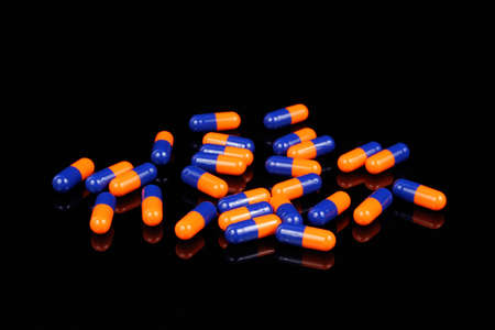 Colorful capsules on Black Backgroundの写真素材