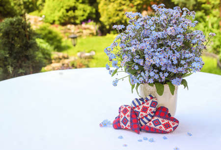 Three hearts with a bouquet of forget-me-nots on a white backgroundの写真素材